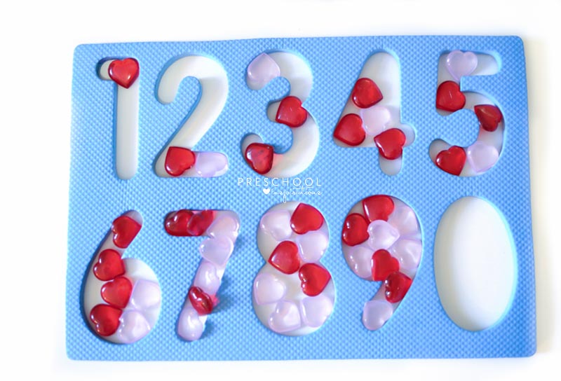 a foam number puzzle filled in with heart gems for each number to teach number sense