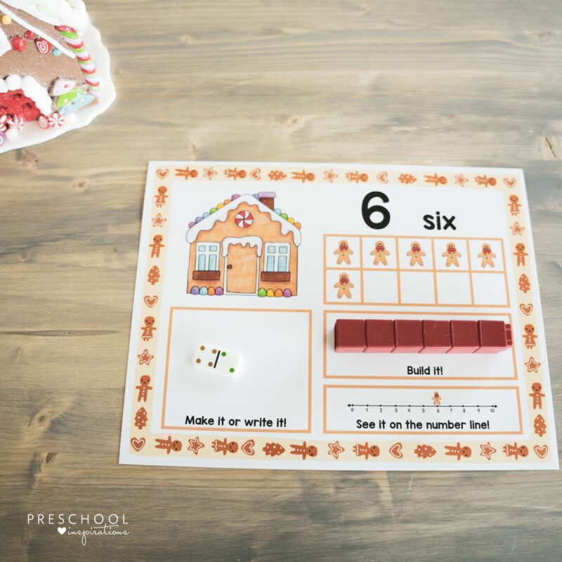 a gingerbread ten frame mat with cube blocks in a row