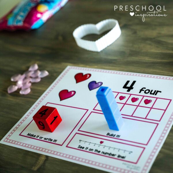 a preschool counting mat themed for Valentine's Day showing a large dice for the number four