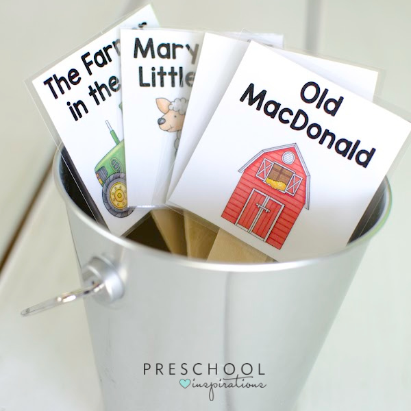four song stick title cards in a small silver bucket